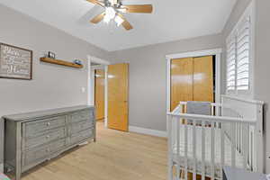 Bedroom featuring ceiling fan and hardwood flooring