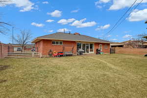 Back of house featuring a lawn and a patio area