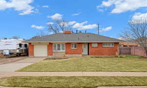 View of front of property with a garage and a front yard