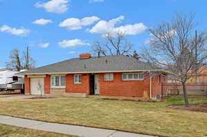 View of front of the house featuring a garage and a yard