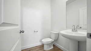 Bathroom featuring toilet and hardwood / wood-style floors