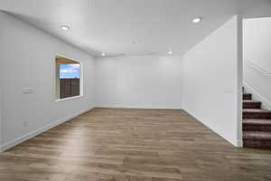 Spare room with hardwood / wood-style flooring and a textured ceiling