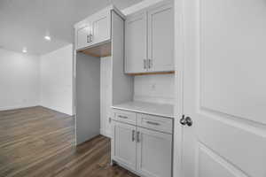 Kitchen with dark wood-type flooring and a textured ceiling