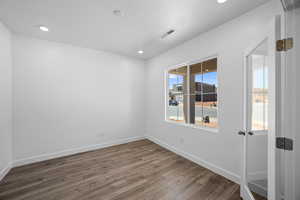 Spare room with dark wood-type flooring