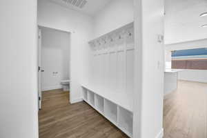 Mudroom featuring wood-type flooring and a textured ceiling