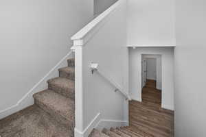 Stairway featuring wood-type flooring