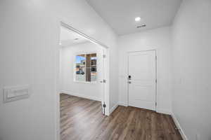 Foyer entrance featuring dark hardwood / wood-style floors