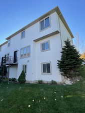 Rear view of house featuring a yard