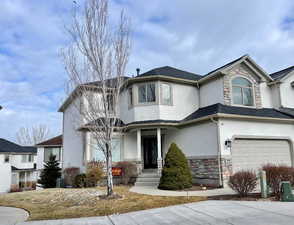 View of front property featuring a garage and central AC unit