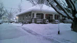 Winter View of front facade with large porch.