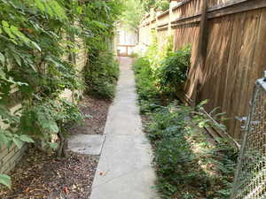 Summer view of pathway to separate entrance for the basement.