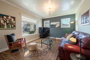 Living room featuring crown molding, hardwood flooring.