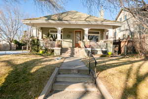 View of front of property featuring the front yard and large covered porch