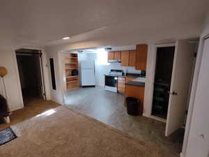 Kitchen featuring  fridge, electric range oven, and sink, all appliances included.