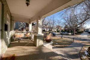 Inviting porch with large patio, on tree lined street