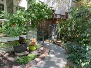 Summer view of pathway leading to a separate entrance for the finished basement.