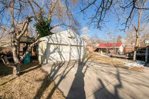 View from front of home featuring an outbuilding to the right of the f photo with red roof, two car  garage with huge attic storage above garage.