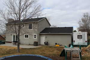 Rear view of house with central AC unit and a patio area