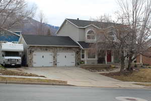 View of front of property featuring a garage and a mountain view