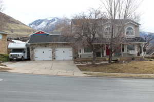 Front of property featuring a garage and a mountain view