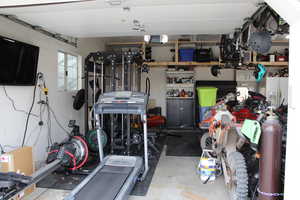 Garage featuring white fridge with ice dispenser