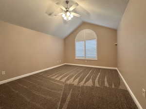 Primary bedroom, new flooring, lofted ceiling,  and ceiling fan