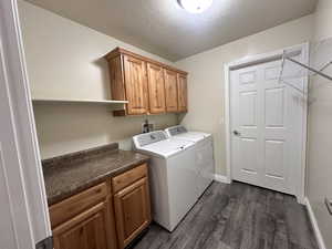 Laundry room featuring cabinet built-ins, new flooring.  Washer and dryer included.