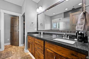 Bathroom with hardwood / wood-style flooring, vanity, and walk in shower