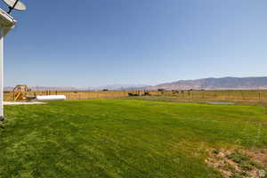 View of yard featuring a playground, a mountain view, and a rural view