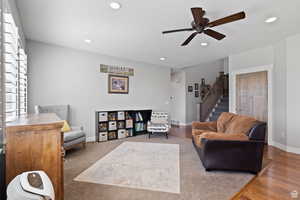 Living room featuring hardwood / wood-style flooring and ceiling fan