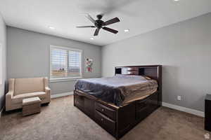 Bedroom with ceiling fan and light colored carpet