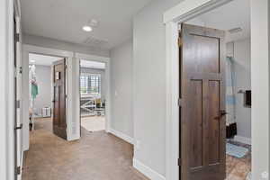 Hallway with light colored carpet