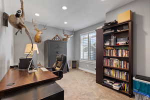 Home office featuring light carpet