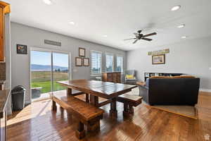 Dining room with a mountain view, dark wood-type flooring, and plenty of natural light