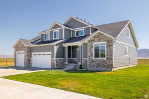 Craftsman-style home with a garage and a front yard