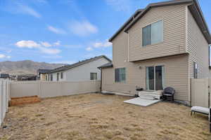 Rear view of property featuring a yard and a mountain view