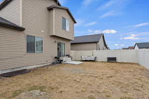 Rear view of house with a yard