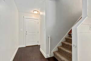 Foyer featuring dark hardwood flooring