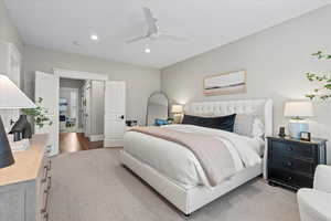 Bedroom featuring light carpet and ceiling fan