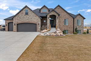 View of front of home featuring a garage and a front lawn