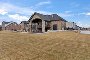 Back of house featuring a lawn