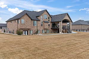 Back of property featuring central AC and a yard