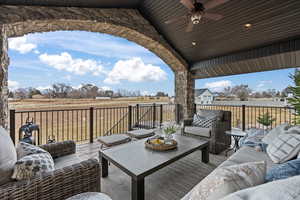 Concrete deck with ceiling fan and an outdoor living space