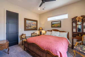 Carpeted bedroom with ceiling fan