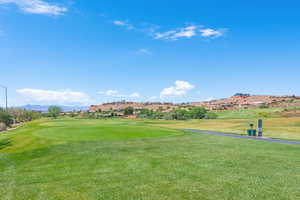 View of property's community with a lawn