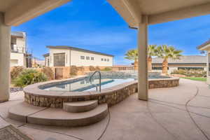 View of patio / terrace featuring a pool with hot tub