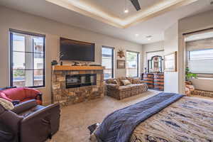 Carpeted bedroom featuring a fireplace