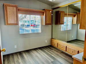 Interior space with lofted ceiling, wood-type flooring, and a closet