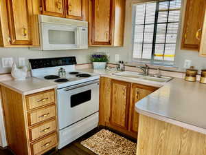 Kitchen with white appliances and sink