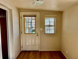 Doorway featuring dark hardwood / wood-style flooring